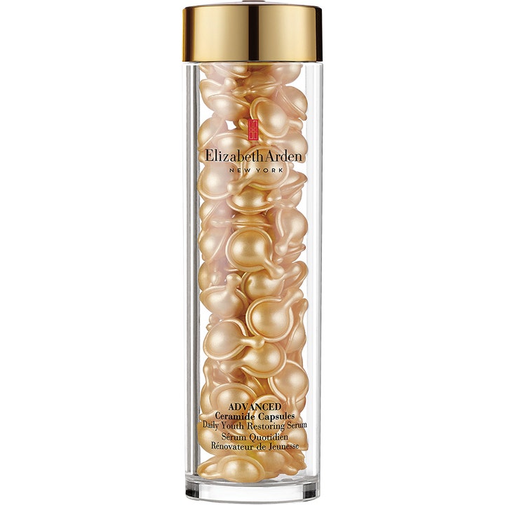 Elizabeth Arden Advanced Ceramide Capsules Daily Youth Restoring Serum styrker huden i klar cylinder med guldkapsler.