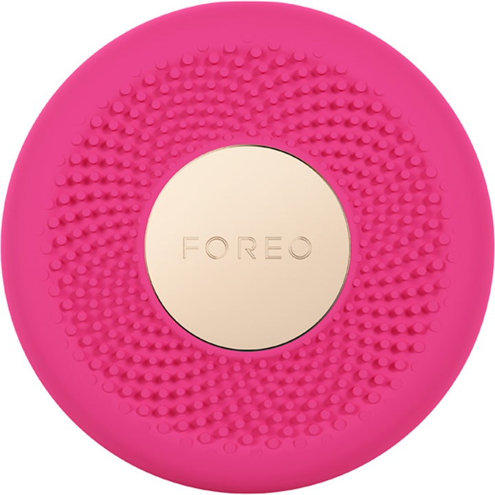 FOREO UFO™ 3 mini 1 stk. fugtgivende ansigtsbehandling fuchsia enhed med nubrede silikonedetaljer og guldlogo