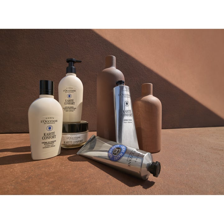 L'Occitane en Provence Shea Butter Hand Cream 150 ml plejende håndcreme i sølvfarvet tube i et varmt livsstilsmiljø