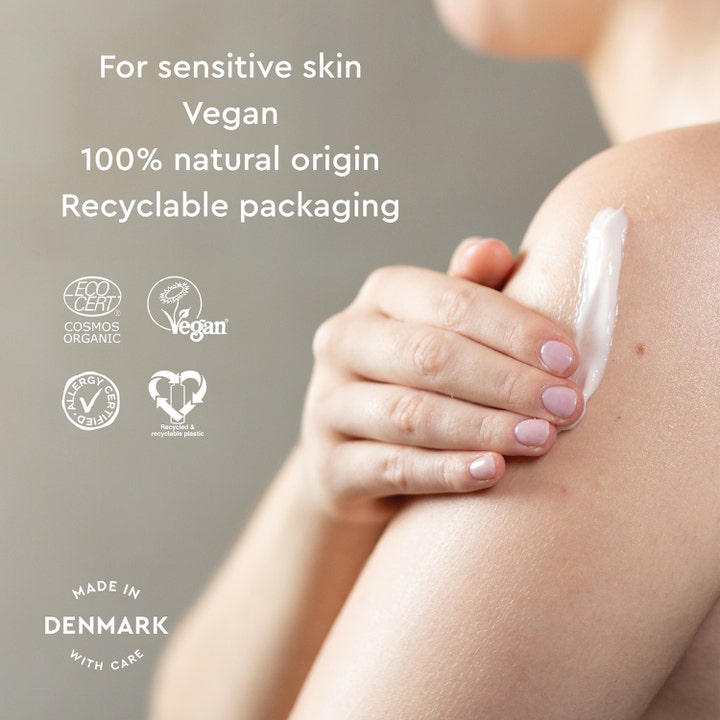 Urtekram Body Lotion Fragrance Free 245 ml til sensitiv hud viser hvid creme på en skulder med Allergy Certified logo