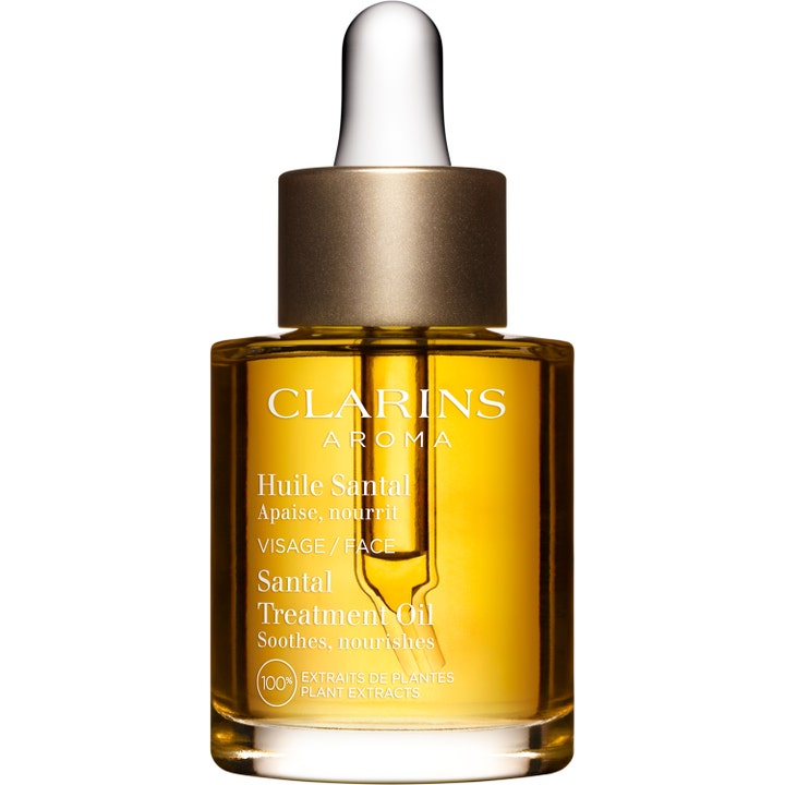 Clarins Santal Treatment Oil 30 ml beroligende ansigtsolie med gul olie i glasflaske og guldfarvet pipette