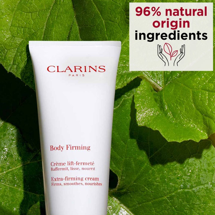 Clarins Body Firming Extra-Firming Cream 200 ml opstrammende kropscreme i hvid tube mod grønne blade.