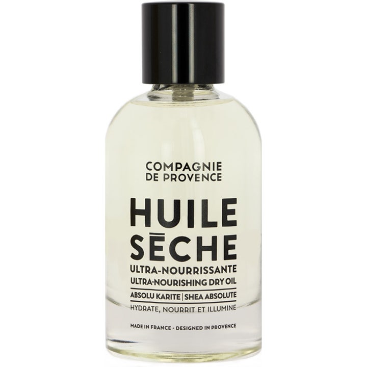 Compagnie de Provence Huile Sèche 100ml nærende tørolie der fugter huden i en klar glasflaske med sort låg.