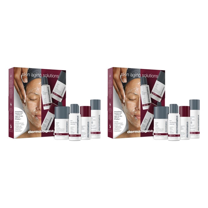 Dermalogica Skin Aging Solutions hudplejesæt mod aldringstegn med hvide og grå tuber foran en mørkerød æske