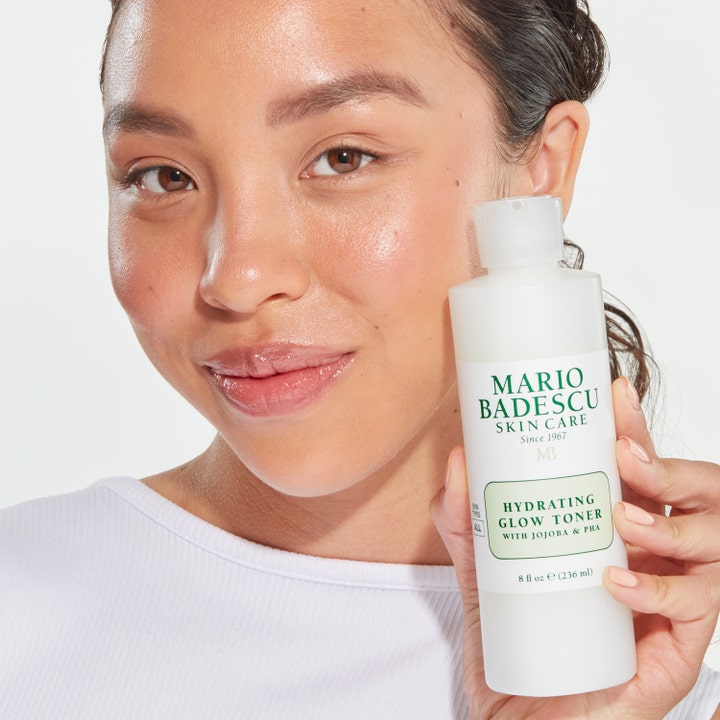 Mario Badescu Hydrating Glow Toner 236 ml fugtgivende toner der giver glød holdt af kvinde med strålende hud.