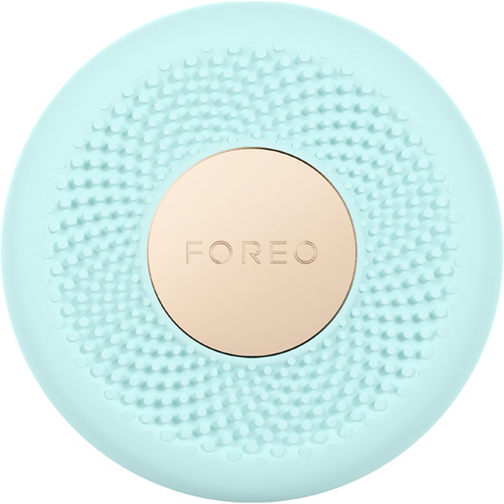FOREO UFO mini 1 stk ansigtsapparat der giver glød i mintgrøn silikone med nubrede detaljer og rund guldplade