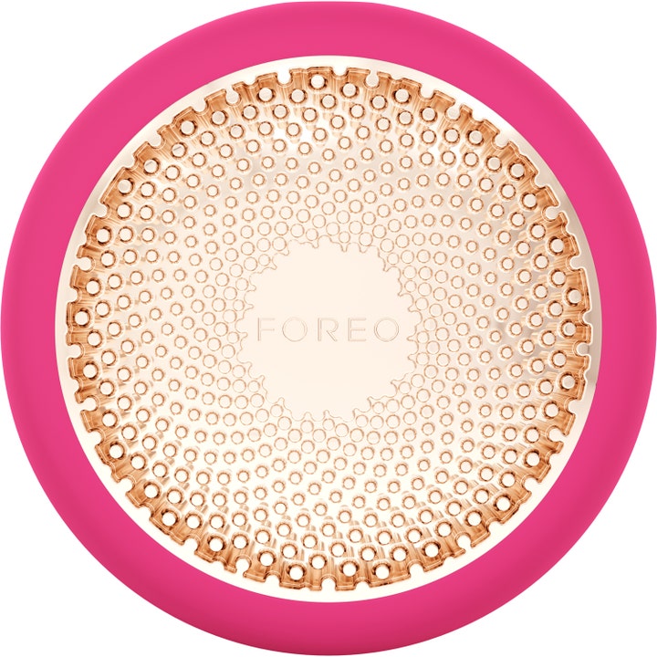 Foreo UFO 1 stk ansigtsbehandling giver glød i en rund pink silikoneenhed med mønstret guldplade.